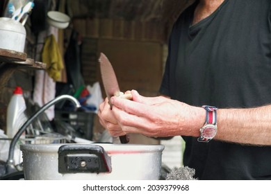 A Seemingly Single Man Cooking On A Messy Kitchen                               