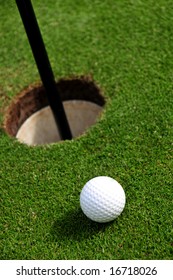 Seen From Above A Golf Ball In Close Proximity To A Hole