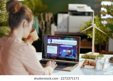 Seen from behind modern woman with laptop using text to image ai image generator in modern office. - Shutterstock ID 2272371171