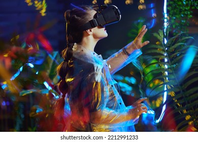 Seen From Behind Stylish 40 Years Old Woman In Virtual Reality In Vr Headset Exploring.