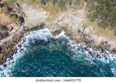 Seen from a bird's eye view, the Pacific Ocean washes against the rocky coast of Northern California in Sonoma. This scenic area runs parallel to the famed Pacific Coast Highway.