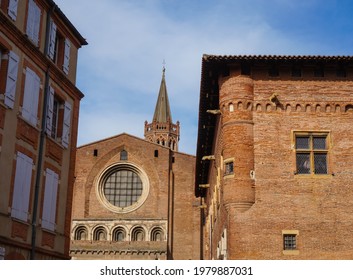 Seen from Emile Carthailac Street in the centre of Toulouse, in the South of France, behind a 16th century, brick Saint-Raymond building, the Western part of the Romanesque Basilica of Saint-Sernin