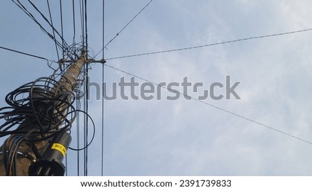 Seen from under an electricity pole with a complicated cable