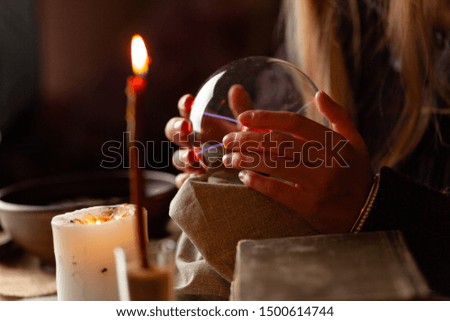 Seer with magic ball performs ritual. Psychic vision, fortune teller.
