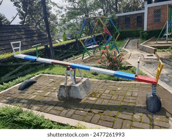 seesaw with some colors in the park - Powered by Shutterstock