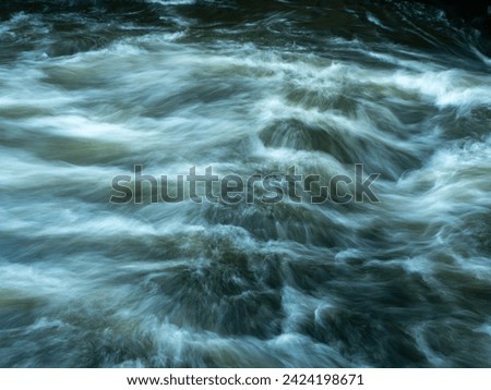 Seething water in a water channel. Fast flowing water of a water channel.