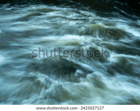 Seething water in a water channel. Fast flowing water of a water channel.