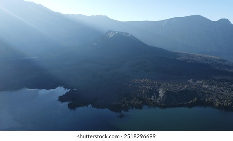 At Segara Anak Lake on Mount Rinjani, a group of young campers enjoys the cool, crisp air by the serene blue waters. Their tents line the lakeshore, creating a peaceful moment in nature’s breathtaking - Powered by Shutterstock