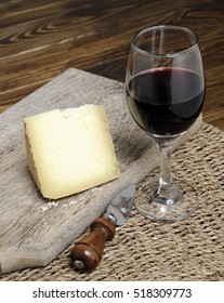 Segment Of Tuscan Pecorino With Glass Of Red Wine