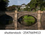 Seimon-seki Bridge and the two-storey keep Fushimi-yagura in the background on a sunny autumn day, Tokyo Imperial Palace, Chiyoda district, Tokyo, Japan