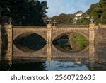 Seimon-seki Bridge and the two-storey keep Fushimi-yagura in the background on a sunny autumn day, Tokyo Imperial Palace, Chiyoda district, Tokyo, Japan