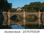 Seimon-seki Bridge and the two-storey keep Fushimi-yagura in the background on a sunny autumn day, Tokyo Imperial Palace, Chiyoda district, Tokyo, Japan