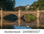 Seimon-seki Bridge and the two-storey keep Fushimi-yagura in the background on a sunny autumn day, Tokyo Imperial Palace, Chiyoda district, Tokyo, Japan