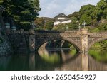 Seimon-seki Bridge and the two-storey keep Fushimi-yagura in the background on a sunny autumn day, Tokyo Imperial Palace, Chiyoda district, Tokyo, Japan
