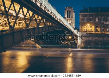 The Seine river long exposure under the bridge with Bateau Mouche passing by