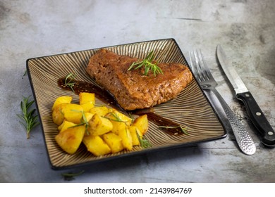 Seitan Steak And Baked Potatoes Plated