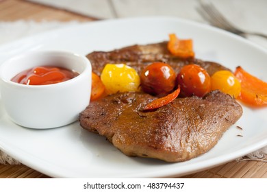 Seitan. Vegetarian Steak Made From Vegan Meat - Seitan, With Cherry Tomatoes And Sauce