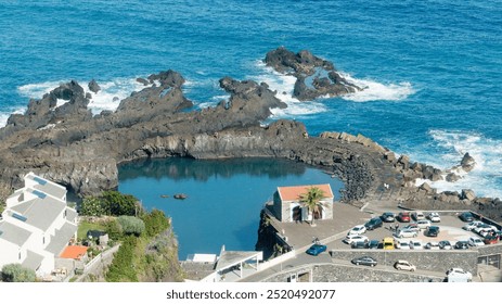 The Seixal Natural Pools on Madeira Island is an incredible collection of volcanic, lava-rock tidal pools, perfect for swimming. - Powered by Shutterstock