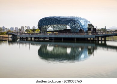 Sejong-si, South Korea - April 15, 2021: Spring view of Floating Stage Island and deck trail with reflection on water at Sejong Lake
