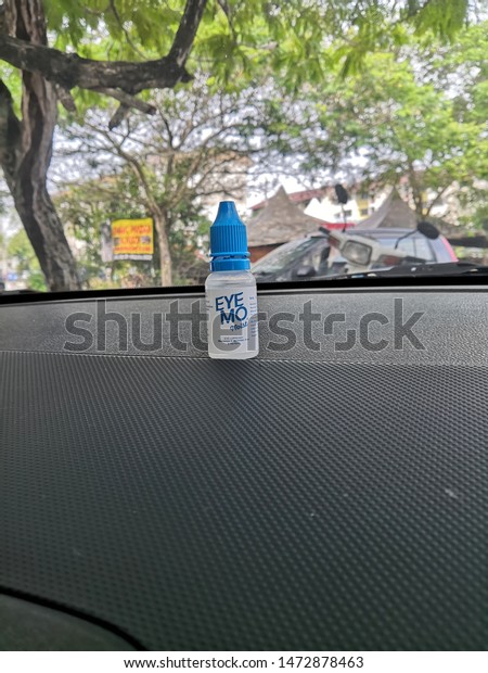 Selangor , Malaysia - August 2019 : Eye Mo eye care\
product on the car dashboard. Eye Mo lubricant is formulated with\
Hypromellose to gently moisturize, comfort and refresh eyes. Made\
in Indonesia. 