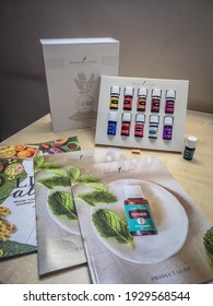 Selangor, Malaysia - February 2021: A Set Of 11 Essential Oils As Starter Kits For New Joiner Of Young Living, With Product Guide And Catalogue. 