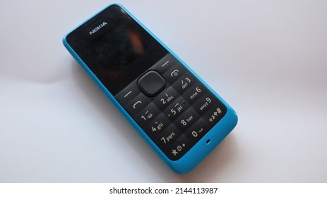 Selangor, Malaysia - Mac 30 2022. Unfocused Image Of Old Nokia 105 In Blue Color. Old Style Phone. Vintage Phone. Push Button Phone.