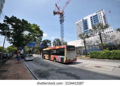 Selangor, Malaysia - March 10, 2022: An Intercity Free Bus For The Public Passing Through The Tower Crane In The City. 