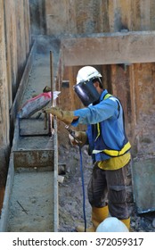 SELANGOR, MALAYSIA Ã¢Â?Â? MARCH 12, 2015: Welder Strengthen The Sheet Pile Cofferdam Retaining Wall. Steel Sheet Pile Used As Temporary Retaining Wall Before Begin The Excavation Works.  