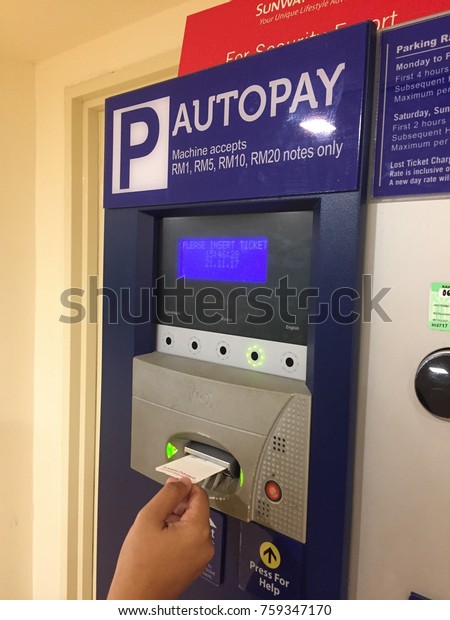 Selangor,\
Malaysia - November 21, 2017 : Pregnant lady using automatic\
parking payment machine also known as Autopay where motorists can\
pay for their parking in shopping\
mall.