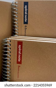 Selangor, Malaysia - Oct 10, 2022: Vertically Arranged Spiral Bound Notebook With Brown Paper Cover At A Bookstore. Books And Stationery Concept.