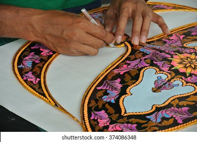 SELANGOR, MALAYSIA â?? SEPTEMBER 6, 2015: Malaysian kite maker working on a kite in his workshop. The traditional kite was called Wau in Malay