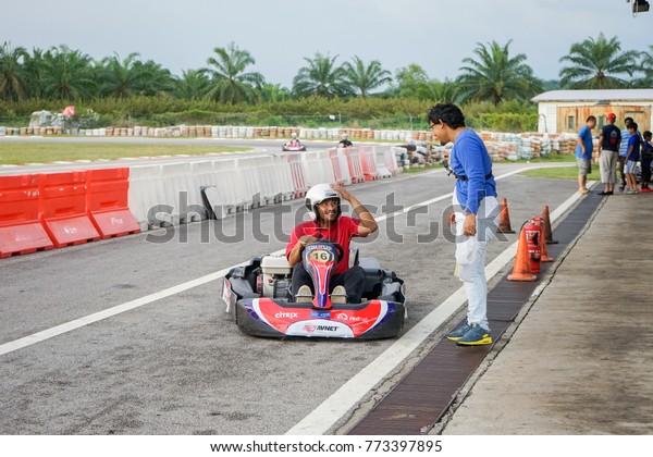 SELANGOR,MALAYSIA - December 11, 2017 : Go Kart\
driver ready to exit the pit after driver changed during fun and\
easy ride for public in Selangor\
Malaysia.