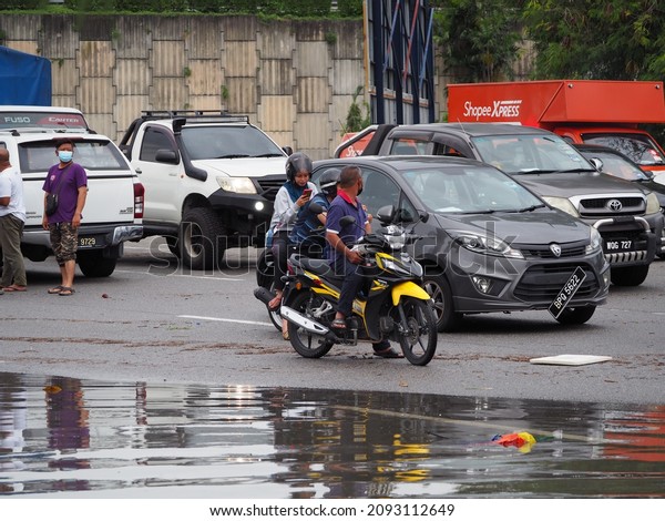 selangor.malaysia.19.12.2021.  Continuous heavy\
rain since morning saw several housing areas in Shah Alam and Klang\
to be inundated. Partially submerged cars are seen on a flooded\
road in Shah\
Alam.