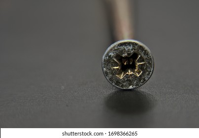 Selby, North Yorkshire, England, Britain, April 2020, Single Screw Head With Shadow On Dark Background