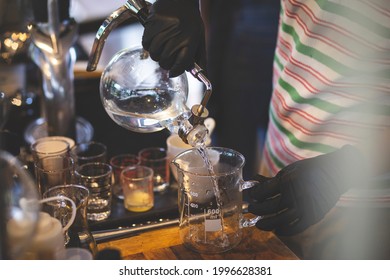 Select The Focus Glass Container After Distillation People Pouring Liquor Liquid In A Glass Jar In A Lab Production And Distillation