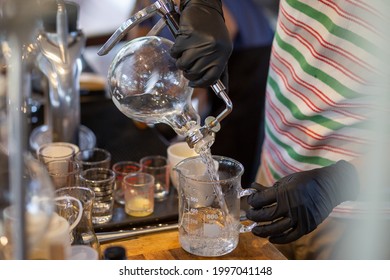 Select The Focus Glass Container After Distillation People Pouring Liquor Liquid In A Glass Jar In A Lab Production And Distillation