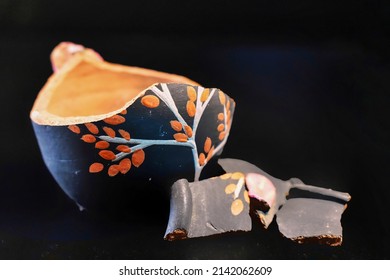 Selected Focus Of Broken Vase Isolated On A Dark Background