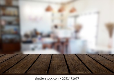 Selected focus empty brown wooden table and Coffee shop or restaurant blur background with bokeh image. for your photomontage or product display - Shutterstock ID 1051491677