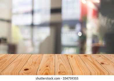 Selected focus empty brown wooden table and Coffee shop blur background with bokeh image, for product display montage. - Shutterstock ID 334759355
