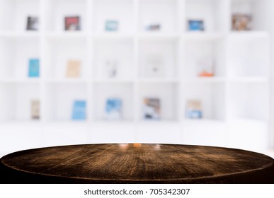 Selected Focus Empty Old Wooden Table And 
Library Or Bookstore Blur Background With Bokeh Image. For Your Photomontage Or Product Display.