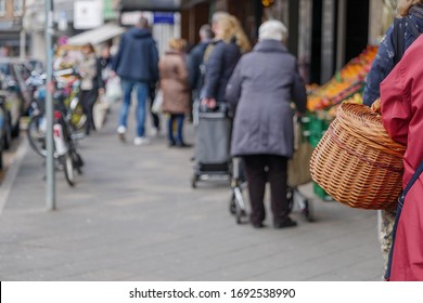 Selected Focus, European People Queue Outside In Front Of Food Stall And Supermarket During Quarantine For COVID-19 Virus In Europe.