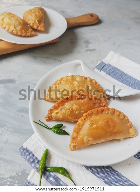 Selected focus on Kue Pastel or Jalangkote, popular\
dish from South East Asia as Curry puff.  This snack filled with\
rice noodles, carrot, potatoes and served with green chili for its\
spicy taste