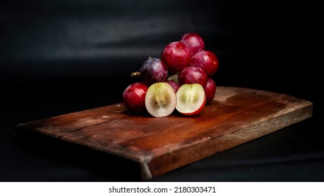 Selected Focus Of Red Grapes Cut In Half Purchased From Supermarkets And Served On The Table, Ready To Be Enjoyed Freshness