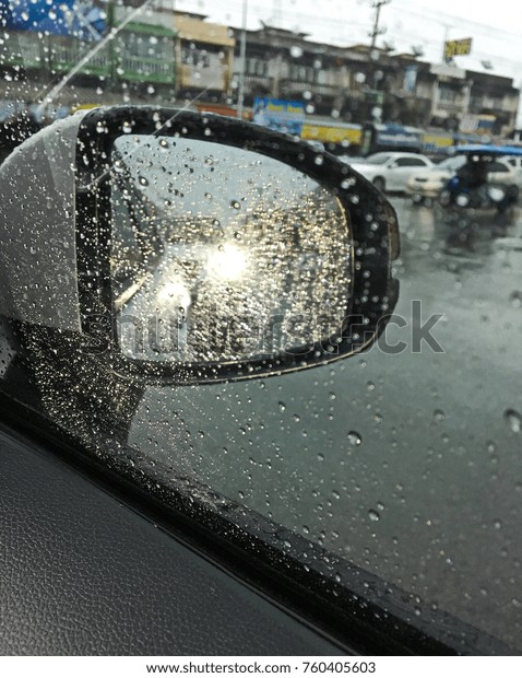 Selected focus. Reflection of warm\
light in car rear view mirror on the road in the evening\
time