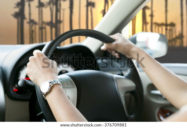 Selected focus Woman is hands on the steering wheel
of the car