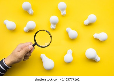 Selected great ideas concepts with male hand using magnifying glass looking for group of lightbulb on color background.Business creativity.human performance - Shutterstock ID 1465779161