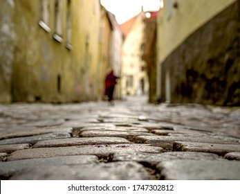 Selectife Focus. Street And Old Town Architecture In Tallinn, Estonia. Old Stone Paved Avenue Street Road. Cobble Stones, Low Angle Shot Of Wet Old Pavement. Filtered Or Toned Image. Copy Space