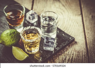 Selection of alcoholic drinks on rustic wood background - Shutterstock ID 570169324