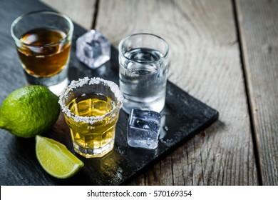 Selection of alcoholic drinks on rustic wood background - Shutterstock ID 570169354