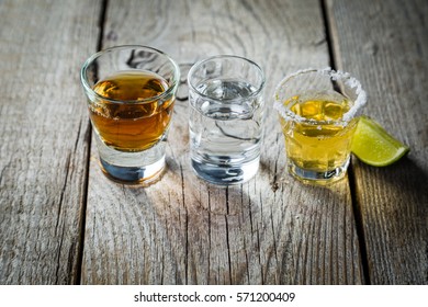 Selection of alcoholic drinks on rustic wood background